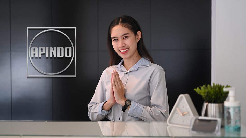 Young asian woman receptionist sitting at reception desk and rai